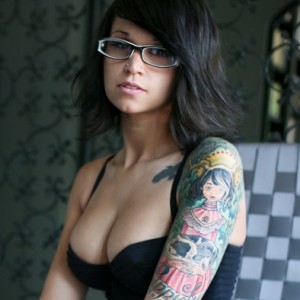 Busty teen showing her inked body